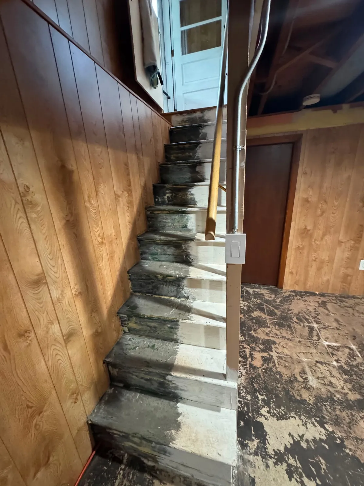 Worn basement stairs before painting
