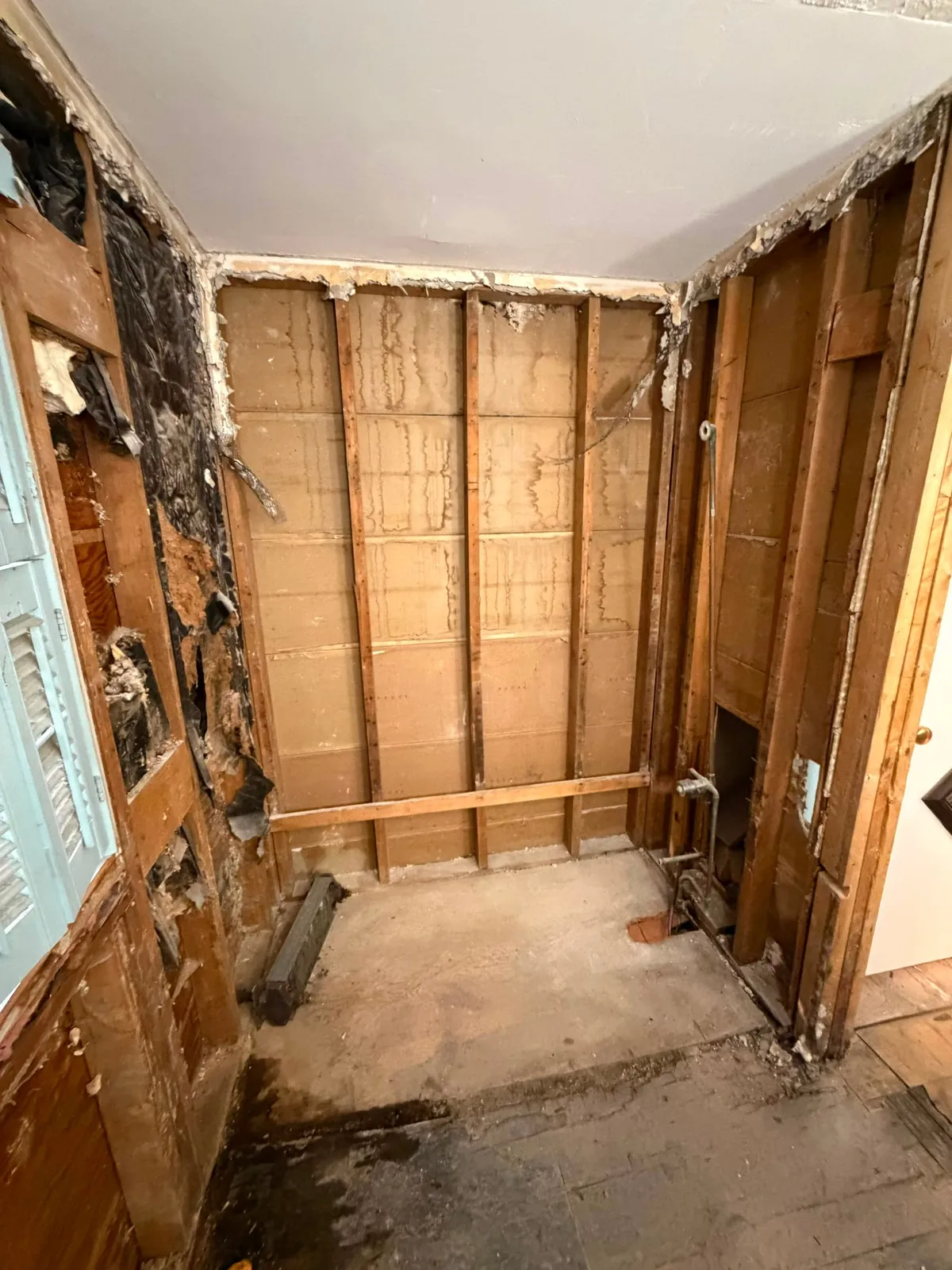 Bathroom stripped to the studs showing water damage