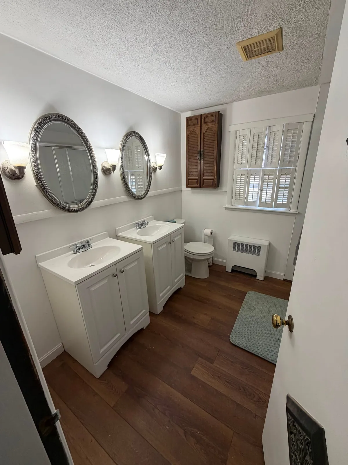 Remodeled bathroom with new white vanities after