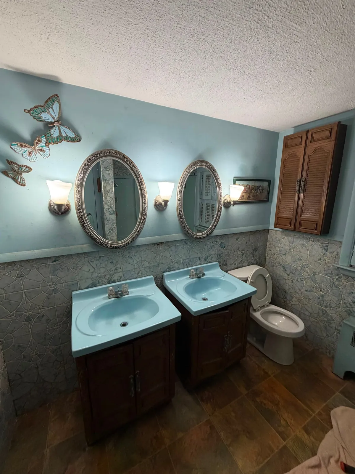 Dated bathroom with blue fixtures before remodel