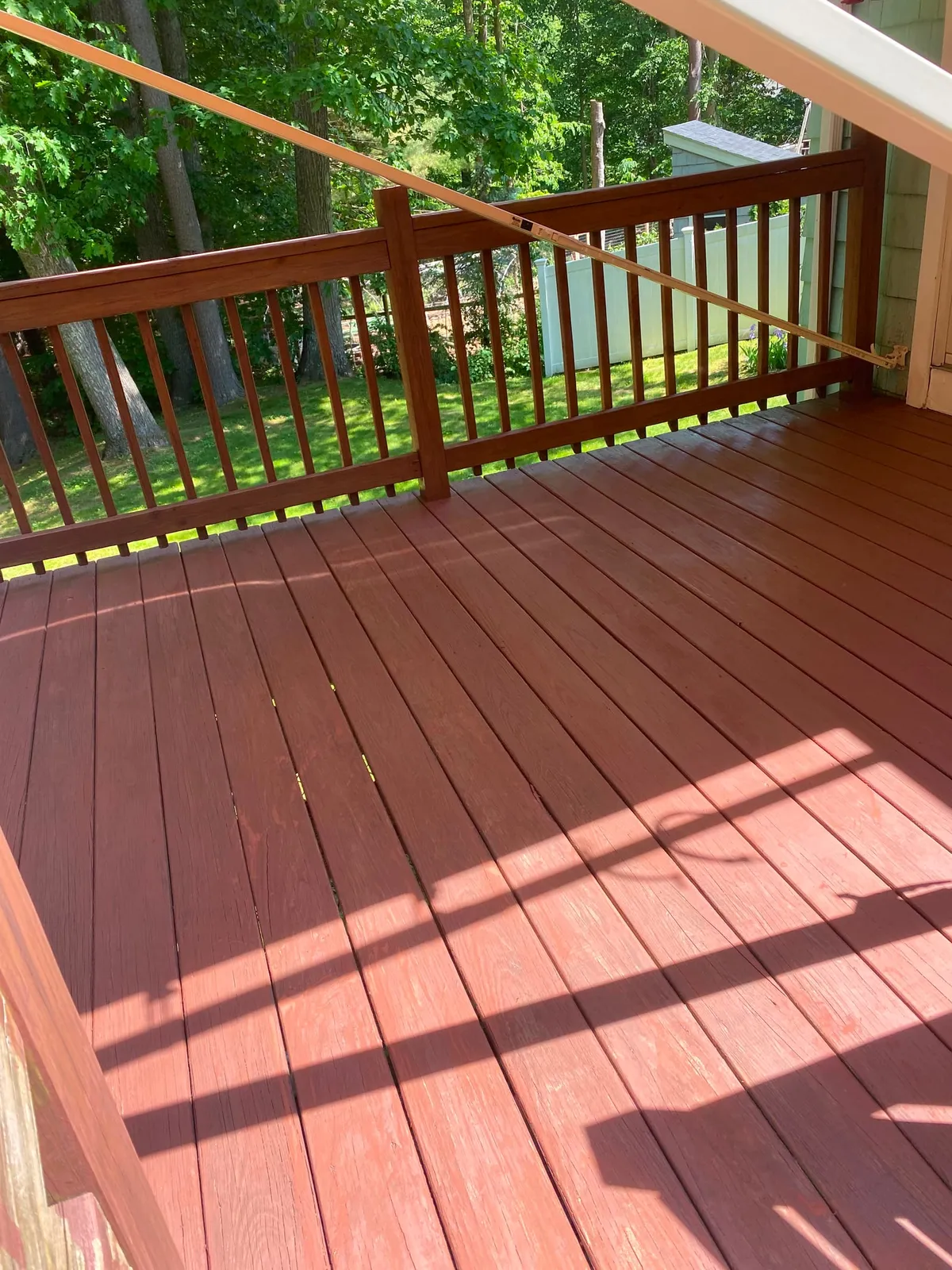Deck refinished with mahogany stain after